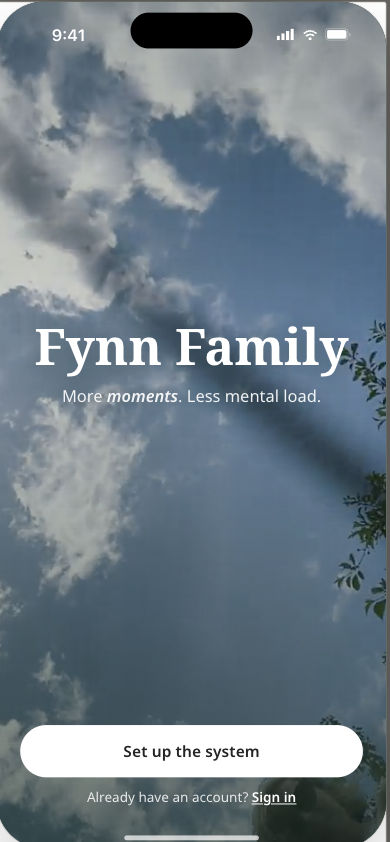 Fynn app splash screen — sunlit sky and clouds, headline 'Fynn Family', tagline 'More moments. Less mental load.', CTA 'Set up the system'.